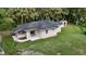 Rear view of home showing the yard and covered patio at 709 S Highland St, Mount Dora, FL 32757