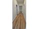 Hallway featuring newly installed light hardwood floors and white trim at 709 S Highland St, Mount Dora, FL 32757