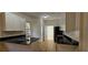 Modern kitchen featuring sleek black countertops, white cabinets, stainless steel appliances, and light wood flooring at 709 S Highland St, Mount Dora, FL 32757