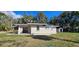 Spacious backyard featuring a well-maintained lawn, exterior storage shed, and home's neutral color palette at 709 S Highland St, Mount Dora, FL 32757