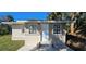 Side exterior view, showing the home's architectural style, yard, and modern concrete entrance at 709 S Highland St, Mount Dora, FL 32757