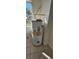 Utility room showcasing a hot water heater, next to a window at 709 S Highland St, Mount Dora, FL 32757