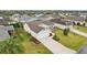 High angle shot of a house with lush lawn, driveway, complemented by a well-maintained garden at 853 Abaco Path, The Villages, FL 32163