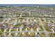 An aerial view of a neighborhood with sidewalks and mature trees, which enhances the community's curb appeal at 853 Abaco Path, The Villages, FL 32163