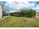 Lush green backyard featuring healthy green grass, manicured hedges, and a serene setting at 853 Abaco Path, The Villages, FL 32163