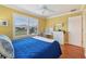 Bedroom featuring a bed, window, and desk area, all illuminated by natural light at 853 Abaco Path, The Villages, FL 32163