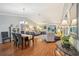 Dining area showcasing hardwood floors, chandelier, and open view to the living room at 853 Abaco Path, The Villages, FL 32163