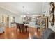 Dining area with hardwood floors, a view to the kitchen, and ample natural light at 853 Abaco Path, The Villages, FL 32163