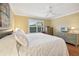 Well-lit bedroom with a ceiling fan and plantation shutters at 853 Abaco Path, The Villages, FL 32163