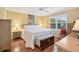 Sun-filled bedroom with plantation shutters and hardwood floors at 853 Abaco Path, The Villages, FL 32163