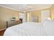 Comfortable bedroom with a ceiling fan and entry to an ensuite bathroom at 853 Abaco Path, The Villages, FL 32163