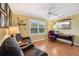 Home office with a ceiling fan, two upholstered chairs, a desk, and a TV at 853 Abaco Path, The Villages, FL 32163