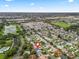 A bird's eye view of the property, highlighting its location near the lake and community amenities at 893 Halstead Ter, The Villages, FL 32162