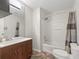 Well-lit bathroom features updated vanity and shower-tub combo at 893 Halstead Ter, The Villages, FL 32162