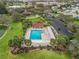 Aerial shot of the community pool and surrounding amenities with lots of parking available at 893 Halstead Ter, The Villages, FL 32162