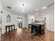 Dining area with wood floors, modern lighting and seating at 893 Halstead Ter, The Villages, FL 32162