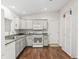 Modern kitchen with white cabinetry, stainless steel appliances at 893 Halstead Ter, The Villages, FL 32162