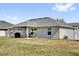 Backyard of the home featuring a covered patio with seating at 9750 Pepper Tree Pl, Wildwood, FL 34785