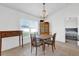 Dining room with a rustic wooden table, traditional decor, and ample natural light at 9750 Pepper Tree Pl, Wildwood, FL 34785