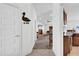 Hallway leading into the Living Room, showcasing tile flooring and neutral wall paint at 9750 Pepper Tree Pl, Wildwood, FL 34785