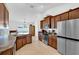 Functional kitchen with stainless steel appliances and warm-toned wooden cabinets at 9750 Pepper Tree Pl, Wildwood, FL 34785