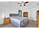 Comfortable main bedroom with a tray ceiling, soft carpet, and neutral color palette at 9750 Pepper Tree Pl, Wildwood, FL 34785