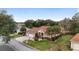 Aerial view of a well-maintained home, a manicured lawn, a paved driveway, and a two-car garage at 9894 Se 138Th Loop, Summerfield, FL 34491