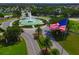 Aerial view of a community fountain with a waving American flag nearby at 9894 Se 138Th Loop, Summerfield, FL 34491