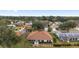 Aerial view showcasing a sunroom, manicured landscaping, and the property's location within a peaceful residential community at 9894 Se 138Th Loop, Summerfield, FL 34491