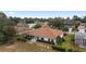 Aerial view of the home's rear featuring a cozy sunroom, meticulously maintained landscaping, and a charming backyard at 9894 Se 138Th Loop, Summerfield, FL 34491