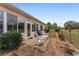 Relaxing back porch with wicker rocking chairs, and views of the backyard and field at 9894 Se 138Th Loop, Summerfield, FL 34491