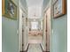 Bathroom hallway view features a bathtub with natural light, and double access to the main bedroom at 9894 Se 138Th Loop, Summerfield, FL 34491