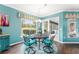 Breakfast nook with seating, dark wood floors, and bright light from a large window at 9894 Se 138Th Loop, Summerfield, FL 34491