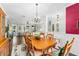 Dining room with chandelier that opens up to the living room and entryway at 9894 Se 138Th Loop, Summerfield, FL 34491