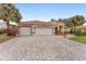 Charming single-story home with a three-car garage and a brick-paved driveway at 9894 Se 138Th Loop, Summerfield, FL 34491