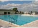 Outdoor pool with lounge chairs and palm trees providing a refreshing retreat at 9894 Se 138Th Loop, Summerfield, FL 34491