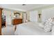 Bedroom featuring wooden furniture, closet space, and natural light at 9906 County Road 114A, Wildwood, FL 34785