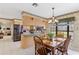 Open concept kitchen and dining area with stainless steel appliances and a view to the living room at 9906 County Road 114A, Wildwood, FL 34785