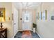 Bright foyer with a decorative front door, chandelier, and neutral wall colors at 9906 County Road 114A, Wildwood, FL 34785