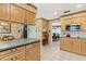 Spacious kitchen featuring bar seating with views into the dining room area at 9906 County Road 114A, Wildwood, FL 34785