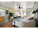 Serene bedroom featuring a cozy bed, well-lit windows, ceiling fan and a decorative ceiling at 102 Palm Way, Tavares, FL 32778