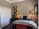 Bright bedroom featuring a unique bed frame, dresser, lamps, and plenty of natural light from the window at 10267 Julia Isles Ave, Oxford, FL 34484