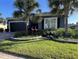 Charming home with mature landscaping, a paver driveway, dark gray trim and a two-car garage at 10267 Julia Isles Ave, Oxford, FL 34484