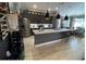 Modern kitchen with stainless steel appliances, a large island with bar seating, and modern pendant lighting at 10267 Julia Isles Ave, Oxford, FL 34484