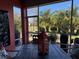Covered patio with a dining area, a view of the landscaped yard, and a relaxing outdoor space at 10267 Julia Isles Ave, Oxford, FL 34484