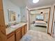 Bathroom with an open view to the bedroom, featuring a vanity and walk-in closet at 104 Chestnut St, Leesburg, FL 34748