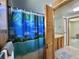 Bathroom features a shower with a tropical themed curtain, and a single sink vanity at 104 Chestnut St, Leesburg, FL 34748
