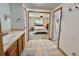 Bathroom with an open view to the bedroom, featuring a vanity and walk-in closet at 104 Chestnut St, Leesburg, FL 34748
