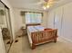 Bedroom with carpeted floors, ceiling fan, a bed, and mirrored closet doors at 104 Chestnut St, Leesburg, FL 34748