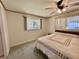 Cozy bedroom with a ceiling fan and bright windows, offering a relaxing space at 104 Chestnut St, Leesburg, FL 34748